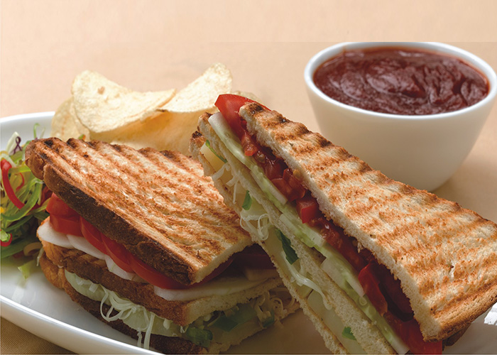 College grill sandwich with fries